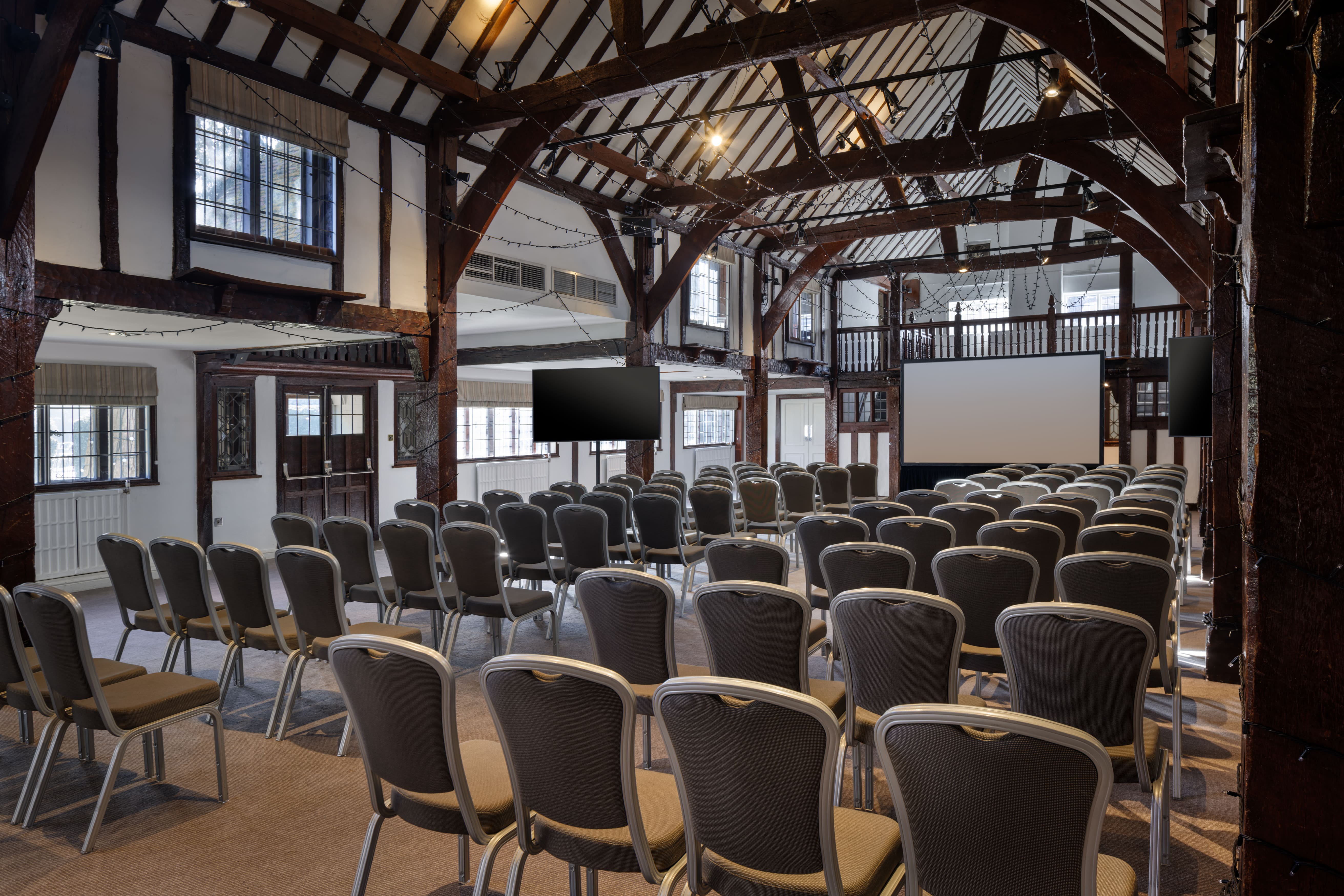 Barn Theatre Conference Setup with Rows of Chairs